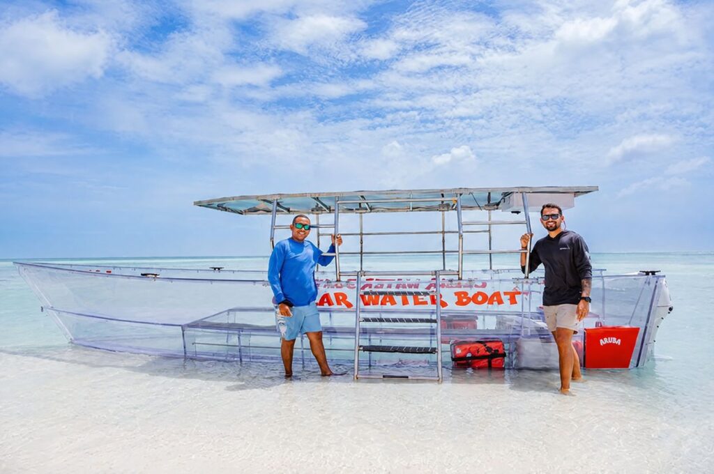 Crew standing beside the clear boat